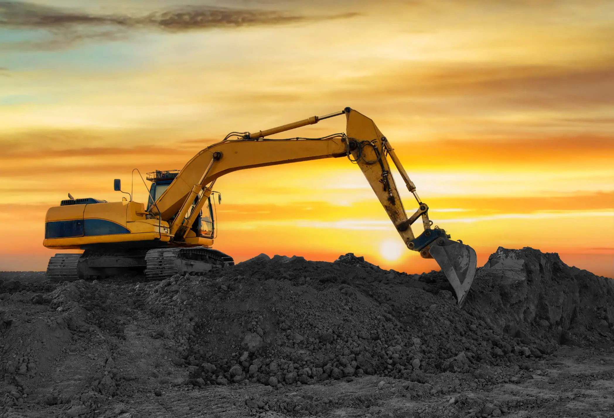 Bulldozer working under a colorful sky
