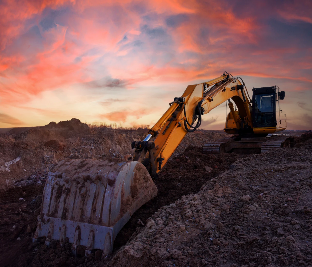 Excavator at sunset on construction site